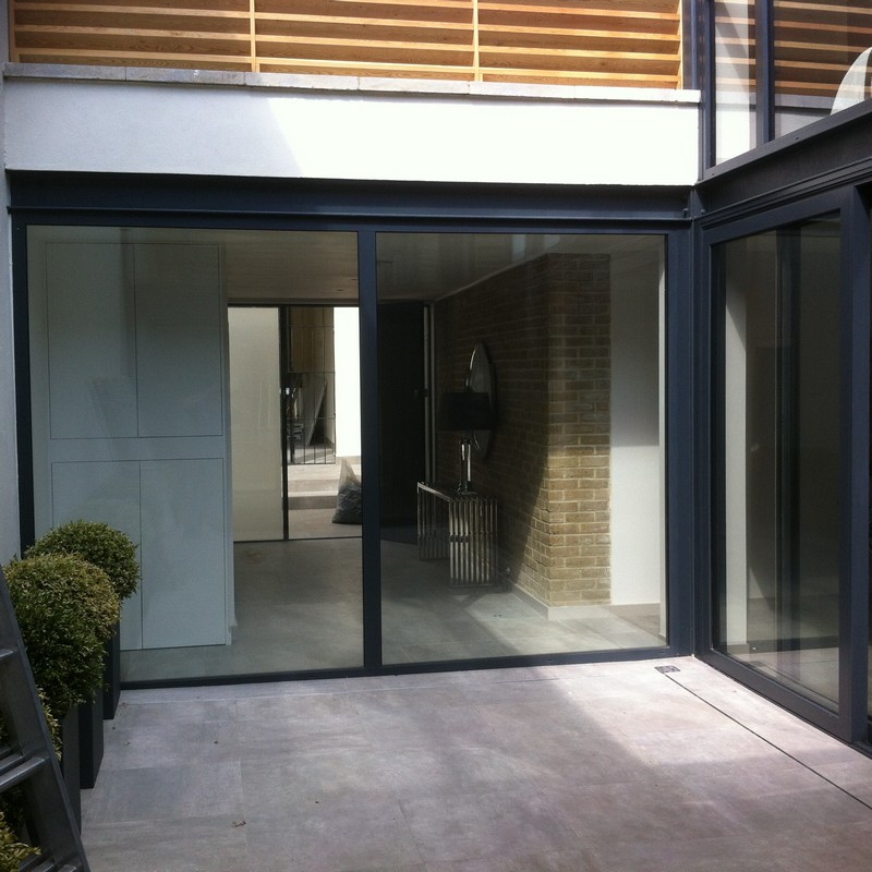 Floor-to-ceiling sliding doors opening to courtyard in Leyton